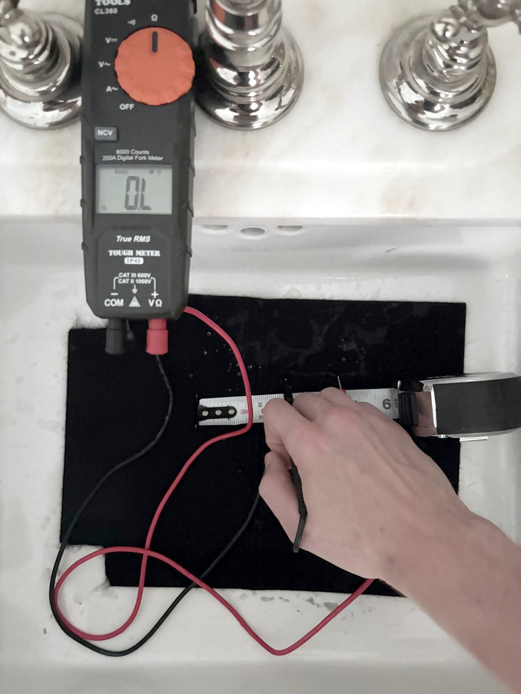 Multimeter reading OL on the megohm range with probes on dry untreated welding blanket