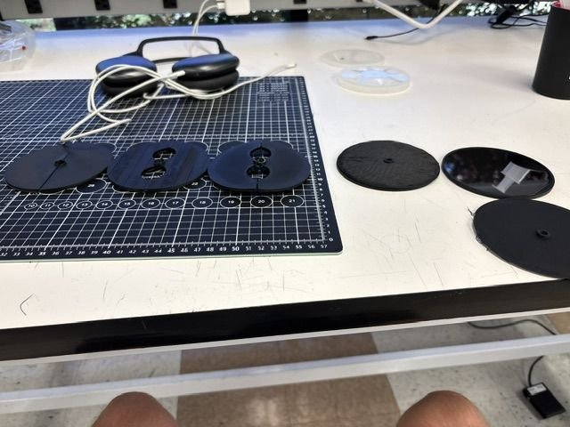 Three printed iterations of the probe case with spare disc blanks