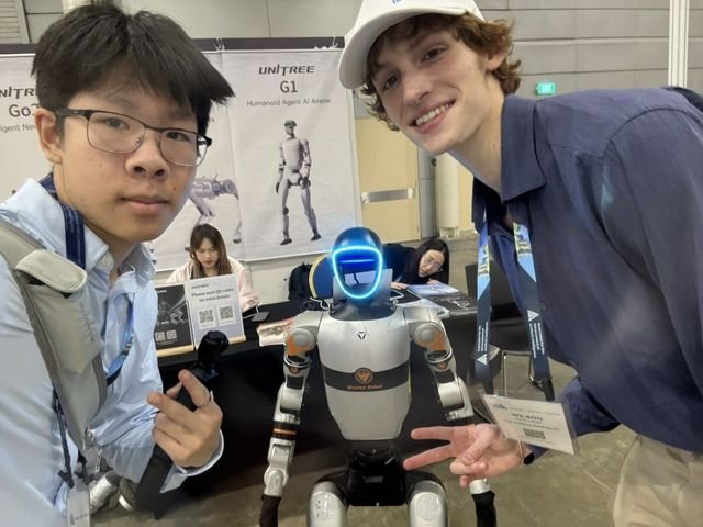 Wilson with a humanoid robot at the AAAI 2026 expo