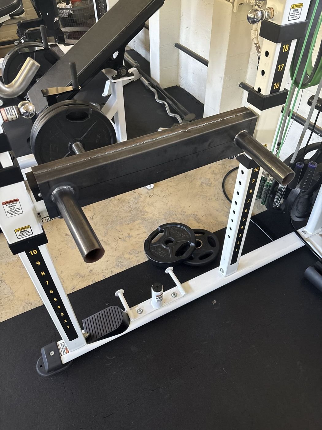 Finished steel dip bar mounted in a power rack